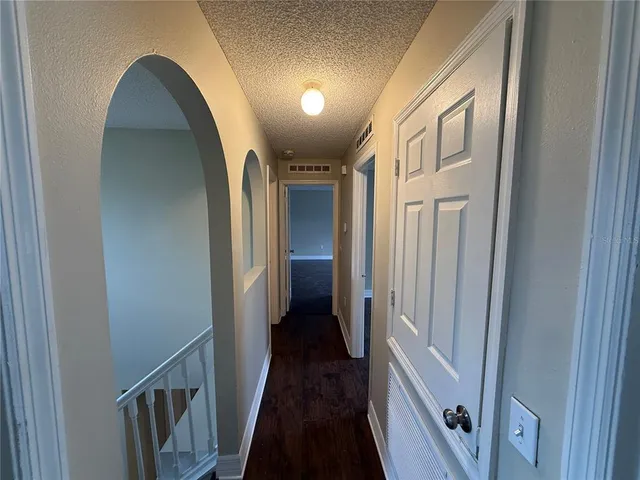 a view of hallway with wooden floor