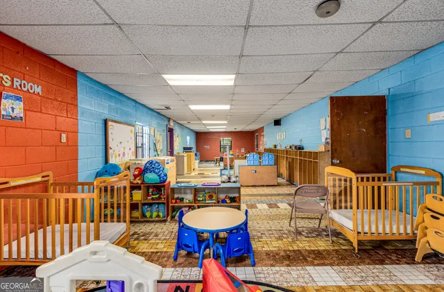a bed room with furniture and a baby crib
