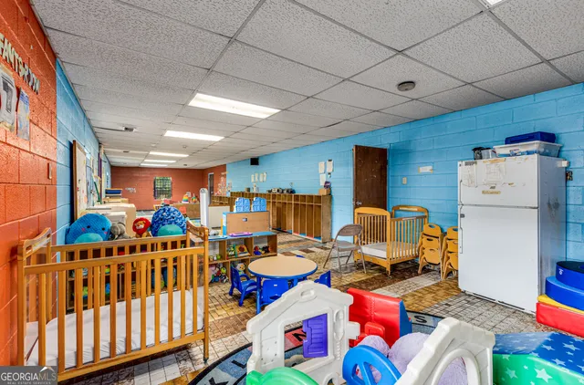 a large living room with stainless steel appliances kitchen island granite countertop a large stove a sink dishwasher and cabinets