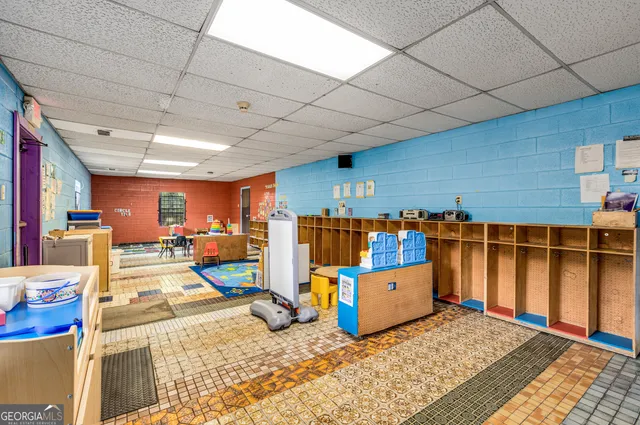 a living room with furniture a wooden floor and next to a window