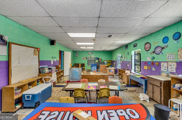 a room with lots of furniture and painting on the wall