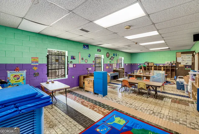 a living room with furniture a rug and a projector