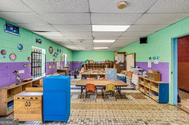 a living room with furniture a rug and a projector