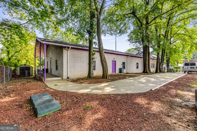 a view of a backyard with swimming pool