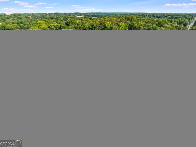 an aerial view of a houses with city view