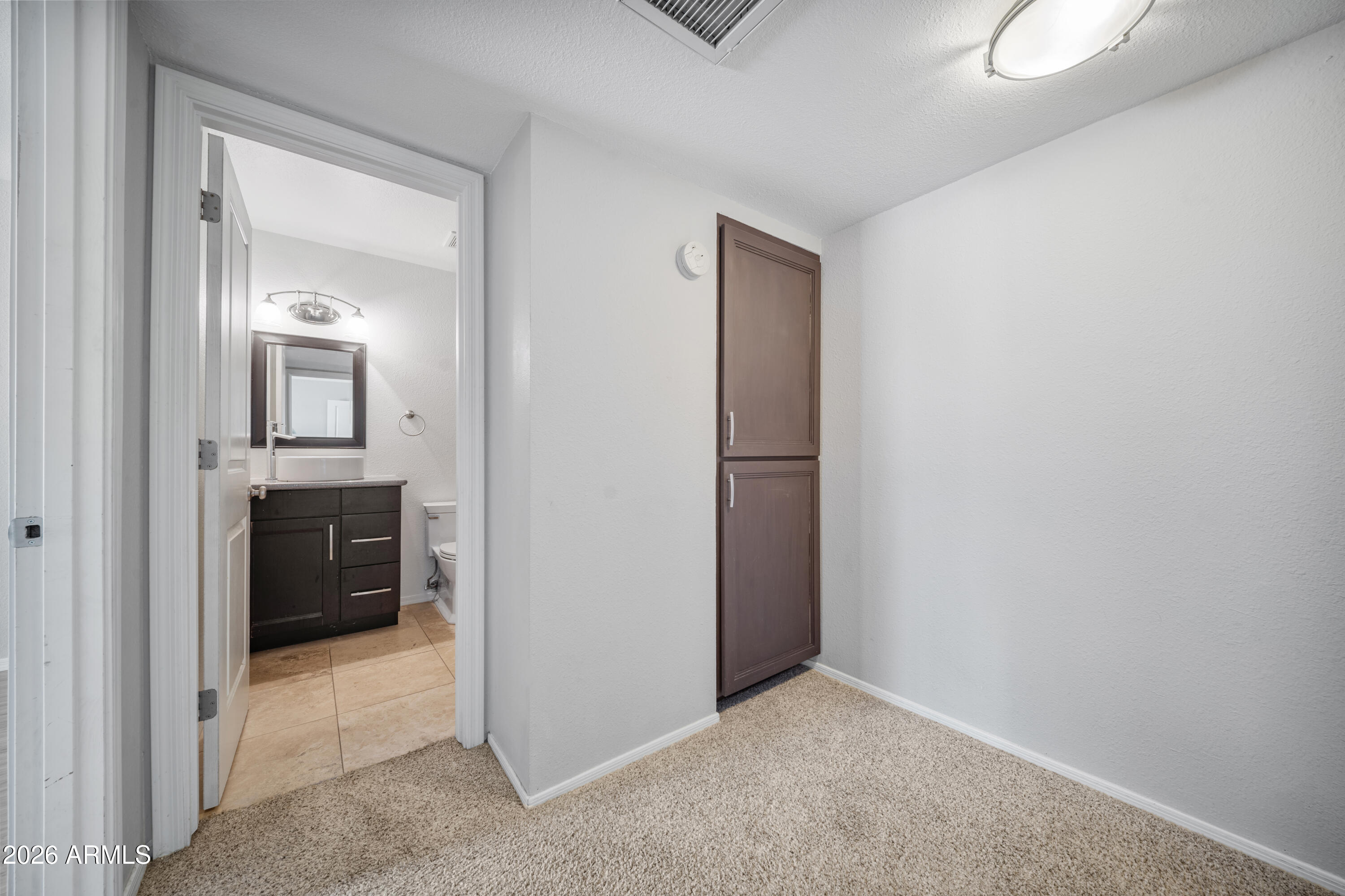 13230 North 3rd Way Phoenix, AZ 85022 - Photo 11 of 22 a view of a hallway and a bathroom with mirror