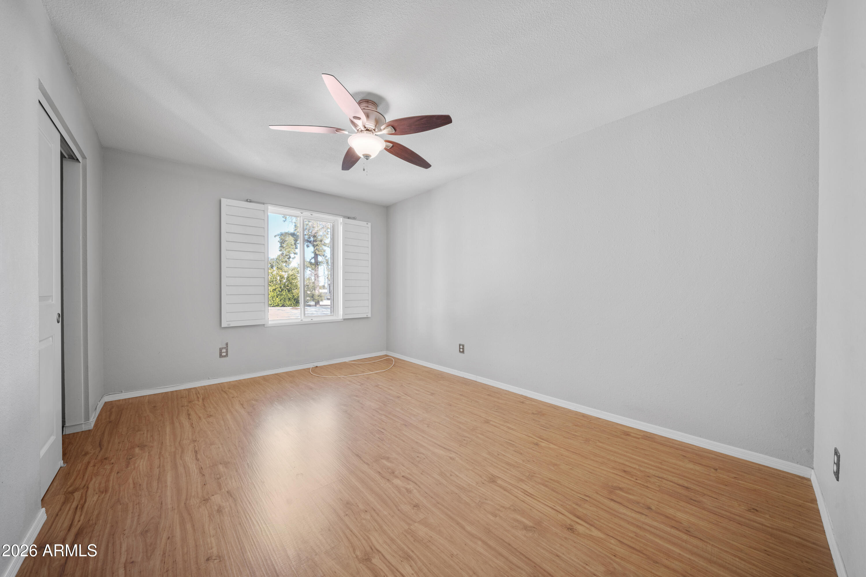 13230 North 3rd Way Phoenix, AZ 85022 - Photo 13 of 22 a view of empty room with wooden floor and fan