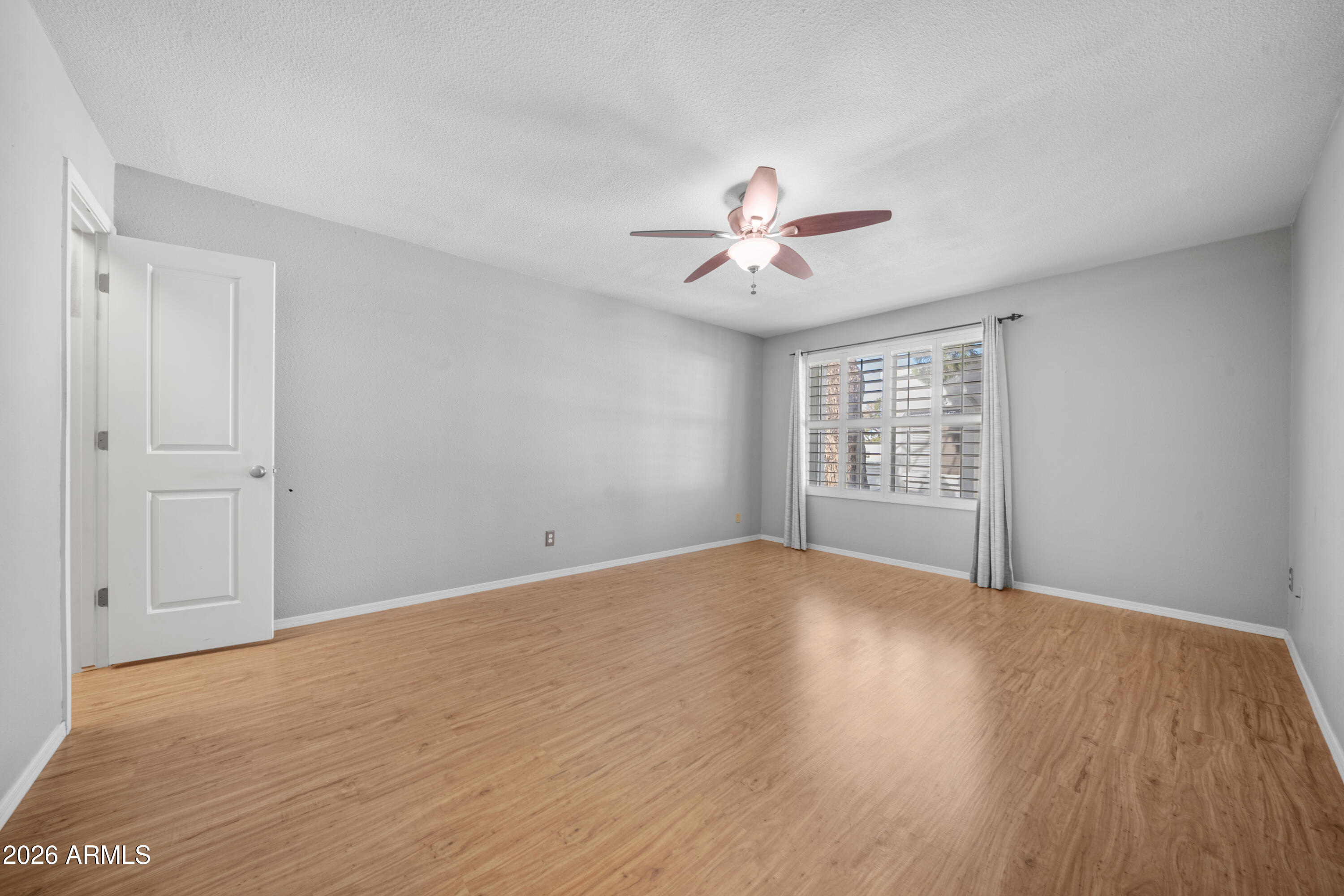 13230 North 3rd Way Phoenix, AZ 85022 - Photo 16 of 22 a view of an empty room with a window and wooden floor
