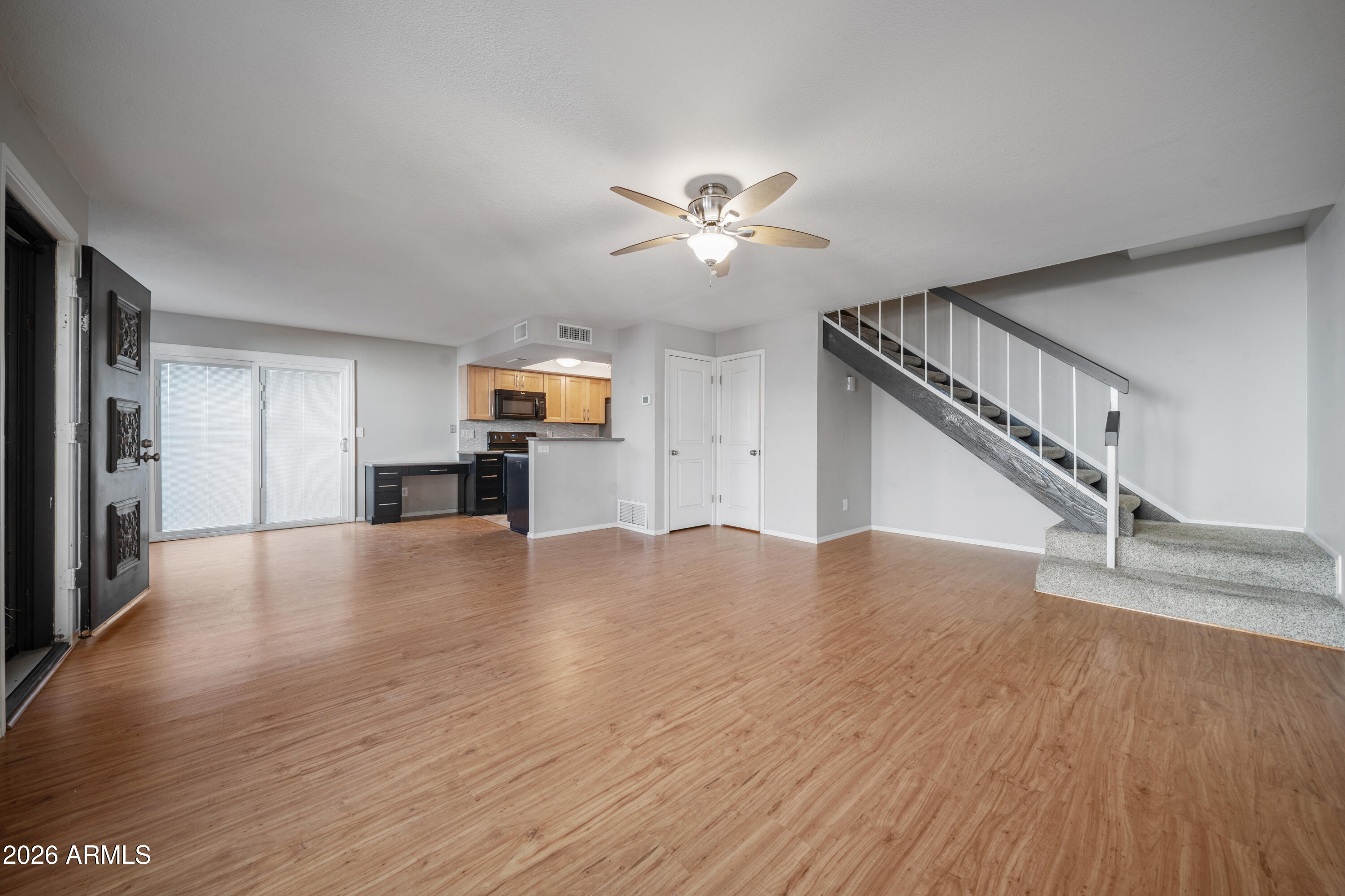 13230 North 3rd Way Phoenix, AZ 85022 - Photo 5 of 22 a view of empty room with wooden floor and ceiling fan