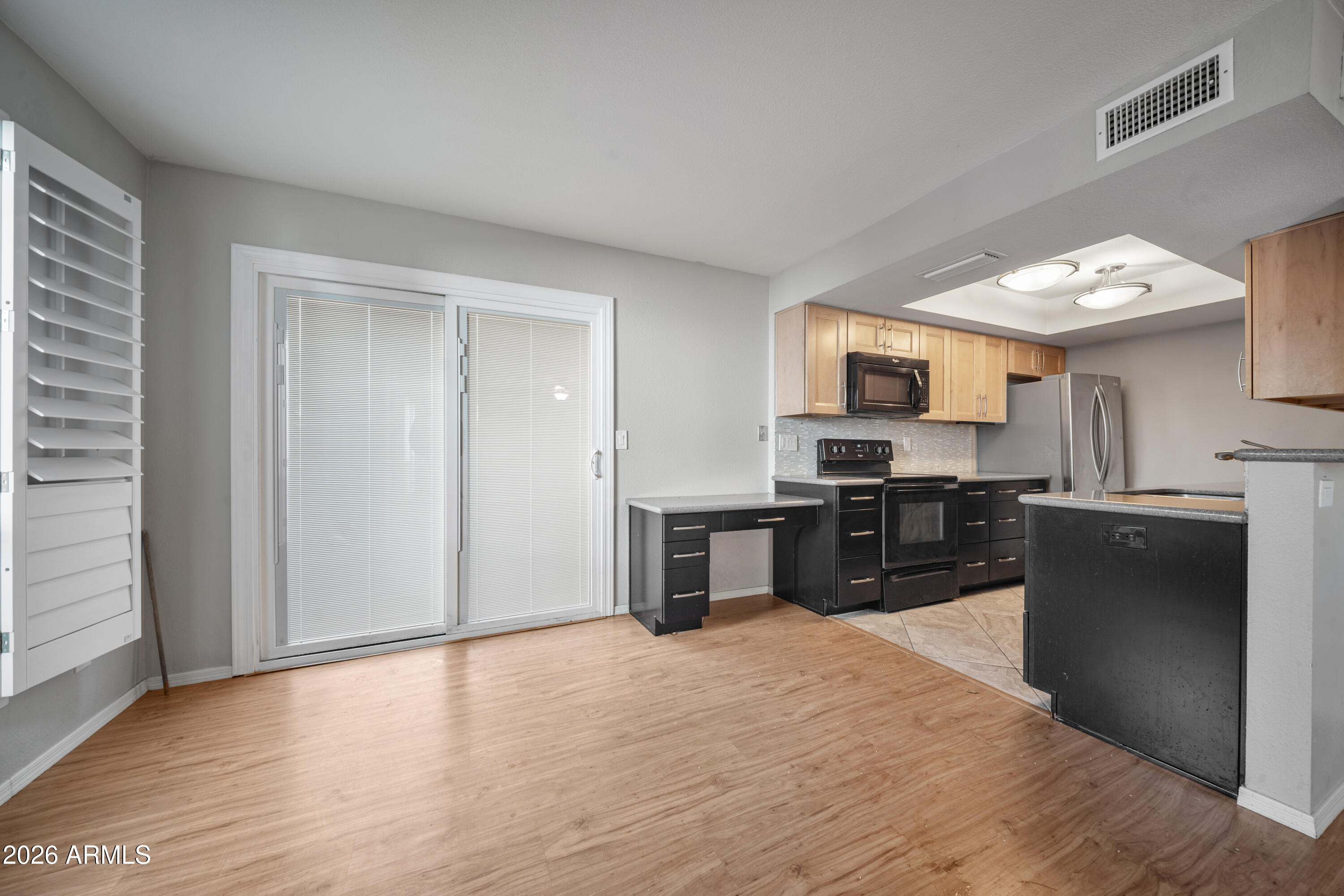 13230 North 3rd Way Phoenix, AZ 85022 - Photo 6 of 22 a kitchen with stainless steel appliances granite countertop a refrigerator and a stove top oven