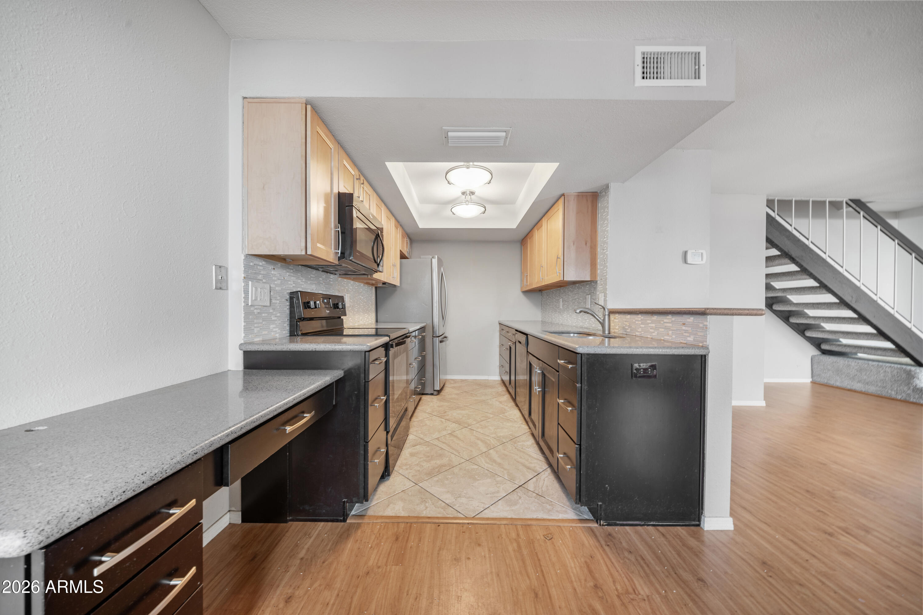 13230 North 3rd Way Phoenix, AZ 85022 - Photo 7 of 22 a kitchen with stainless steel appliances granite countertop a stove and a sink