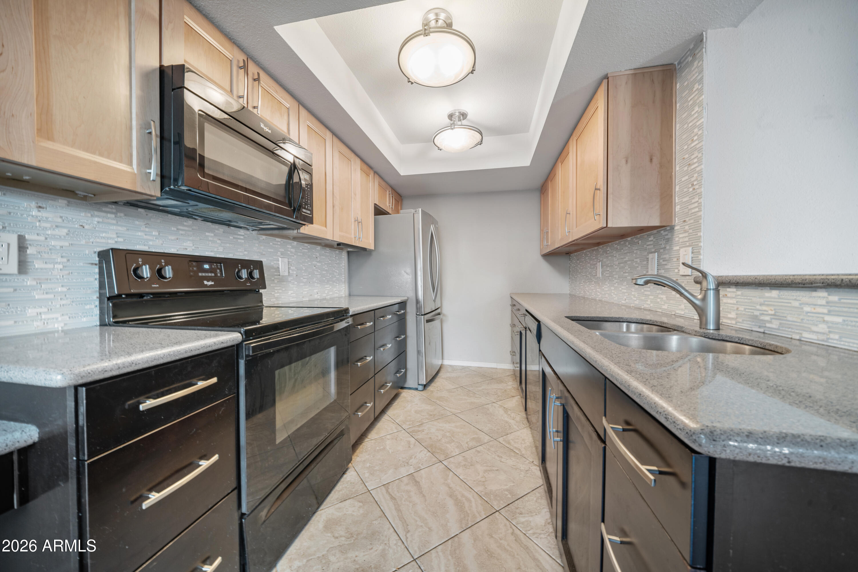 13230 North 3rd Way Phoenix, AZ 85022 - Photo 8 of 22 a kitchen with stainless steel appliances granite countertop a sink a stove and a microwave