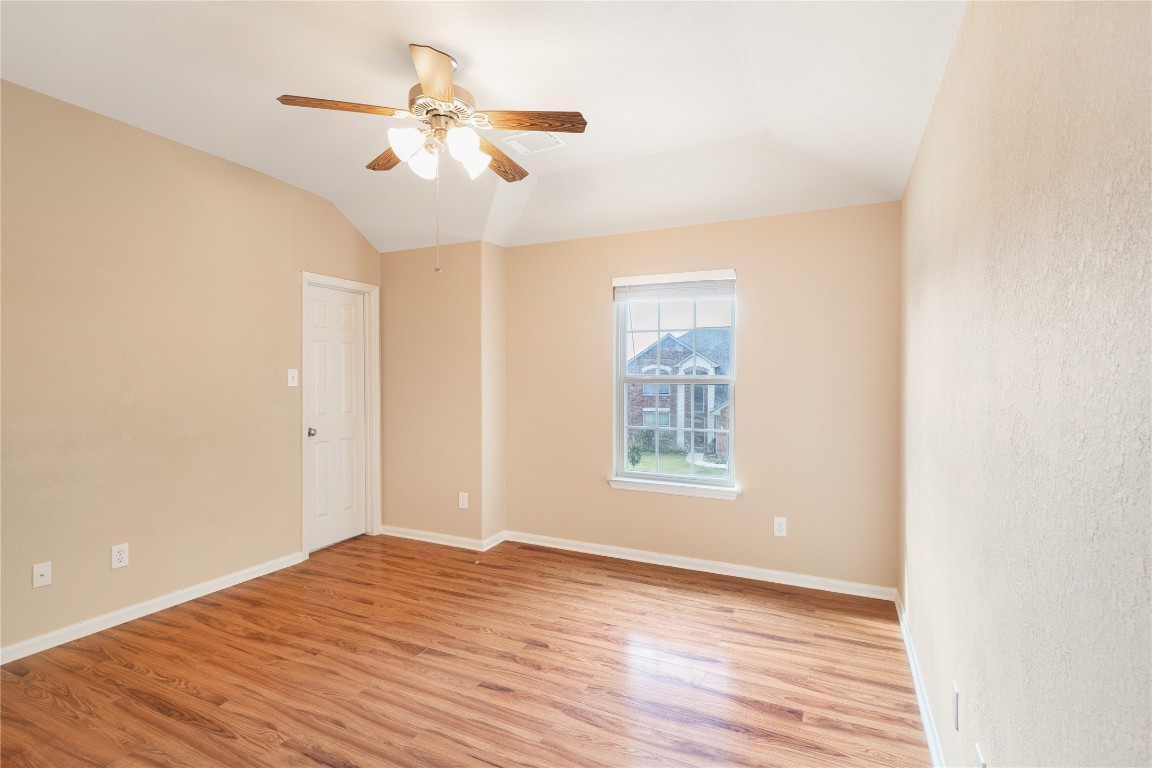 16622 Dover Mills Drive Spring, TX 77379 - Photo 13 of 20 an empty room with wooden floor fan and windows
