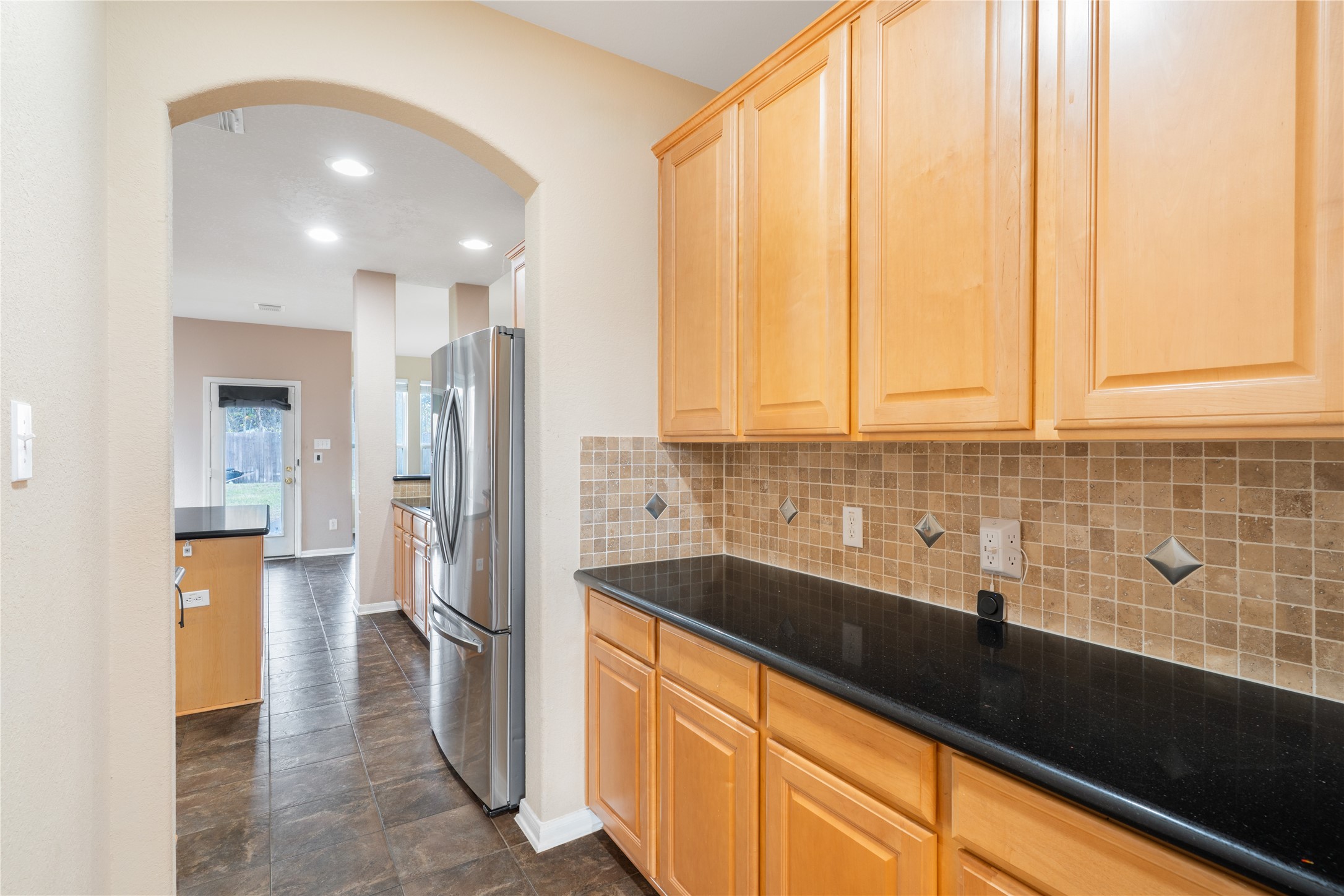 16622 Dover Mills Drive Spring, TX 77379 - Photo 3 of 20 a kitchen with stainless steel appliances a sink stove and refrigerator