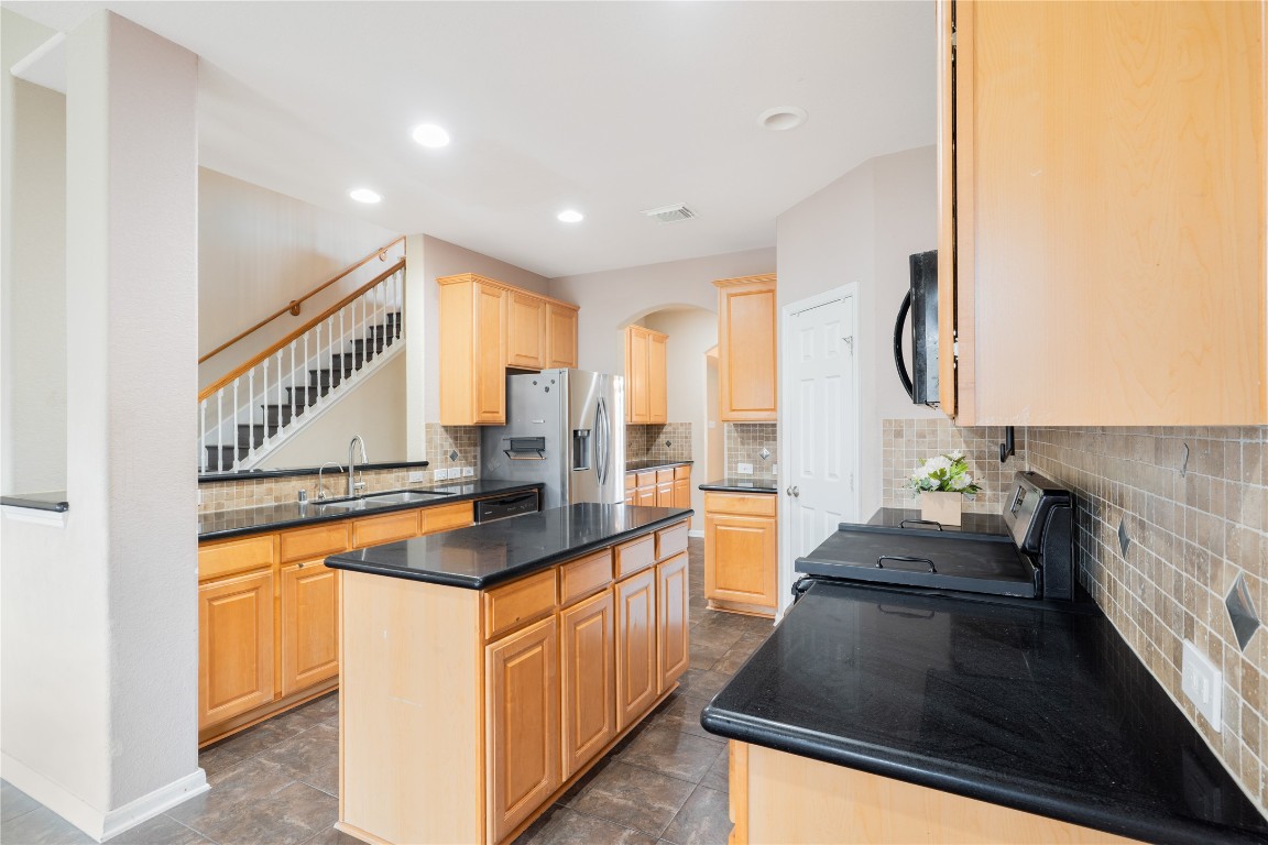 16622 Dover Mills Drive Spring, TX 77379 - Photo 5 of 20 a kitchen with stainless steel appliances granite countertop a stove and a sink