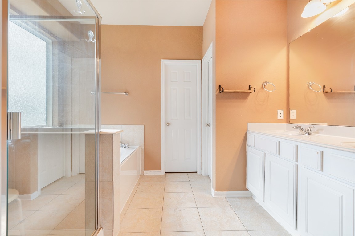 16622 Dover Mills Drive Spring, TX 77379 - Photo 10 of 20 a bathroom with a granite countertop sink a mirror and a shower