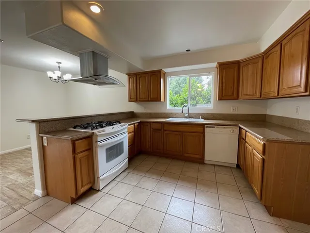 a kitchen with a stove sink and cabinets