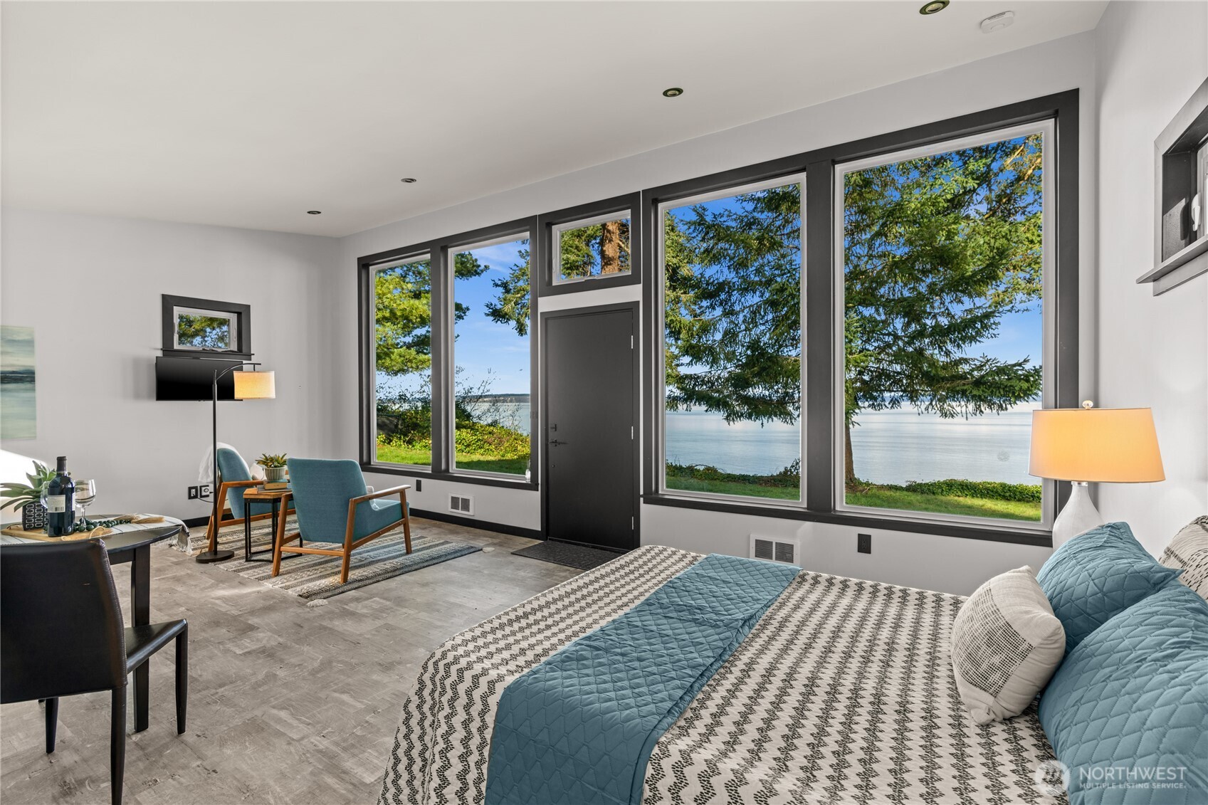 33244 Eglon Road Northeast Kingston, WA 98346 - Photo 30 of 40 a bedroom with a bed and large windows