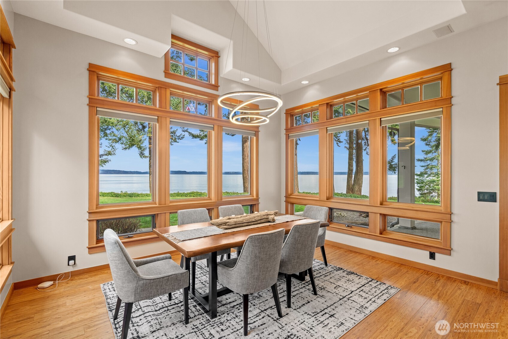 33244 Eglon Road Northeast Kingston, WA 98346 - Photo 8 of 40 a view of a dining room with furniture wooden floor and a rug