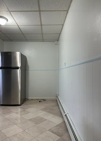 a view of a refrigerator in a kitchen