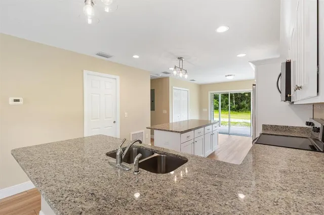 a large white kitchen with a large tub and sink