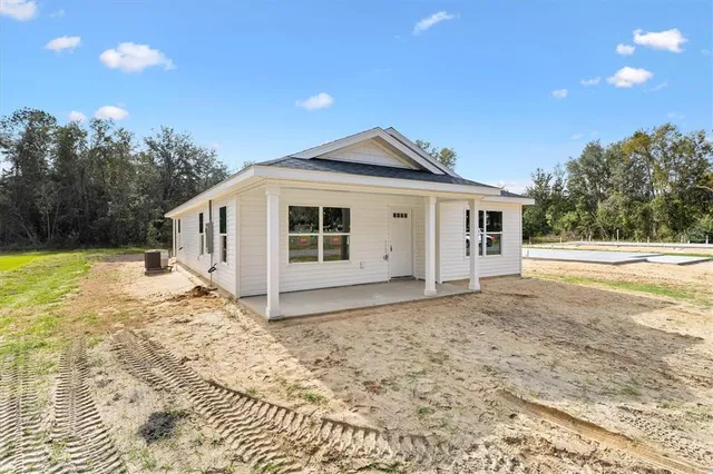 a view of a house with a yard and sitting area