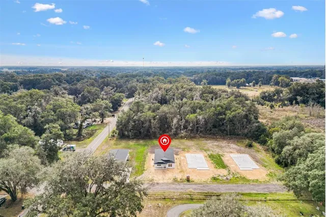 an aerial view of residential houses with outdoor space and swimming pool