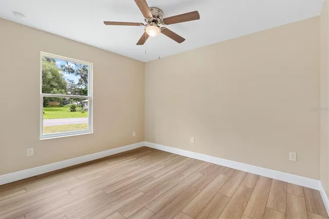 wooden floor in an empty room with a window