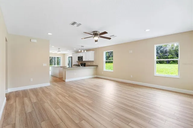 a view of a kitchen with wooden floor and a kitchen