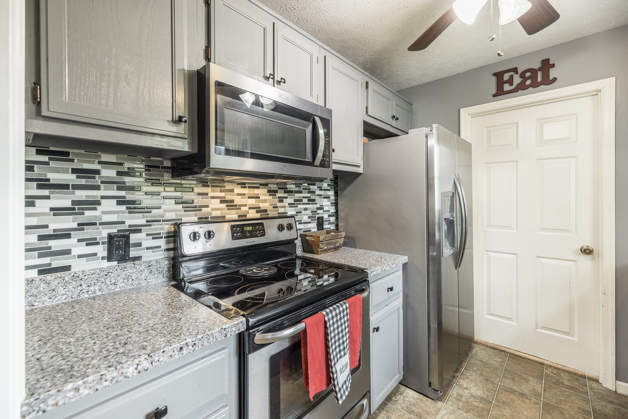 3000 Tom Austin Highway Springfield, TN 37172 - Photo 11 of 32 a kitchen with stainless steel appliances granite countertop a stove microwave and refrigerator