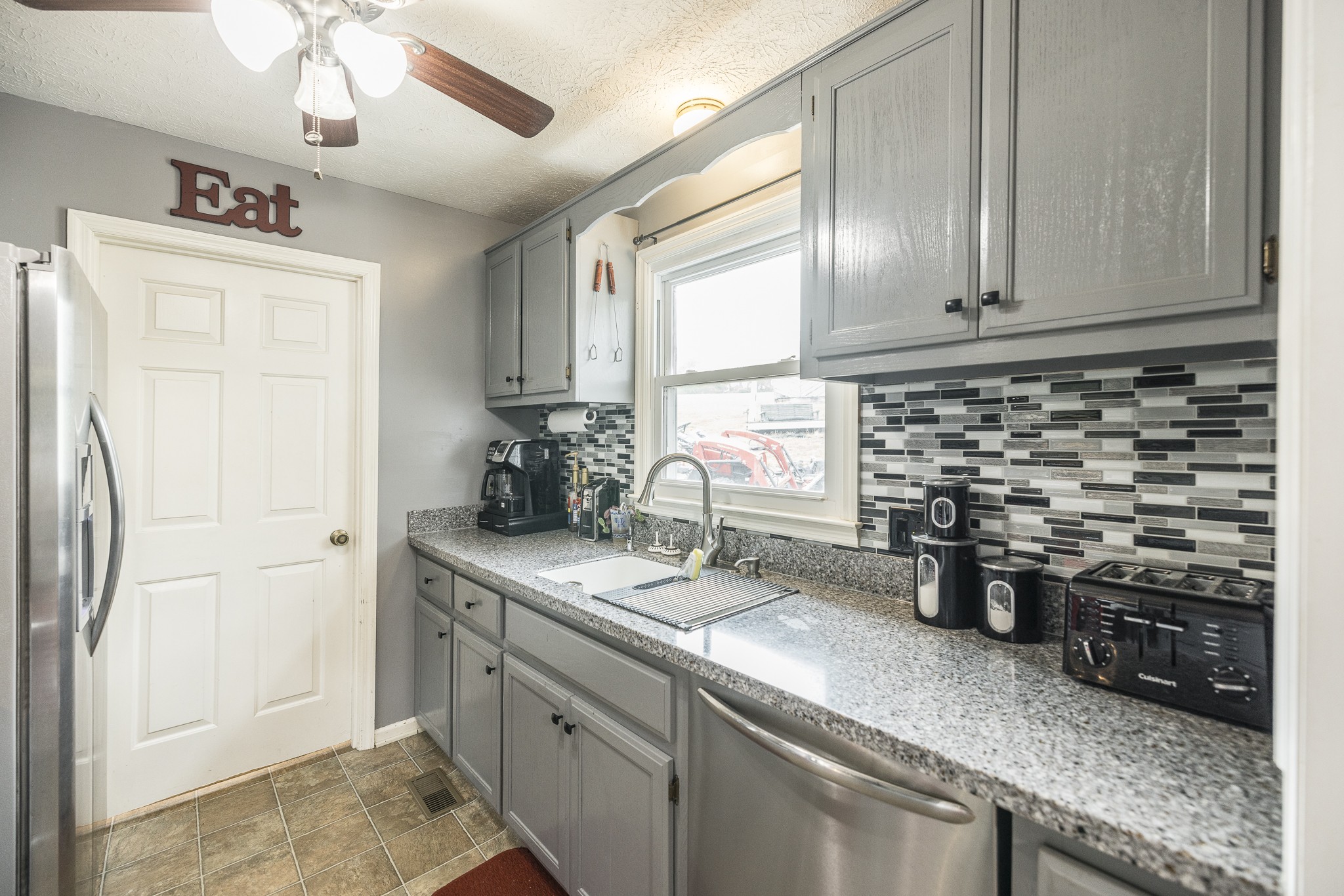 3000 Tom Austin Highway Springfield, TN 37172 - Photo 10 of 32 a kitchen with stainless steel appliances granite countertop a sink a stove and a refrigerator