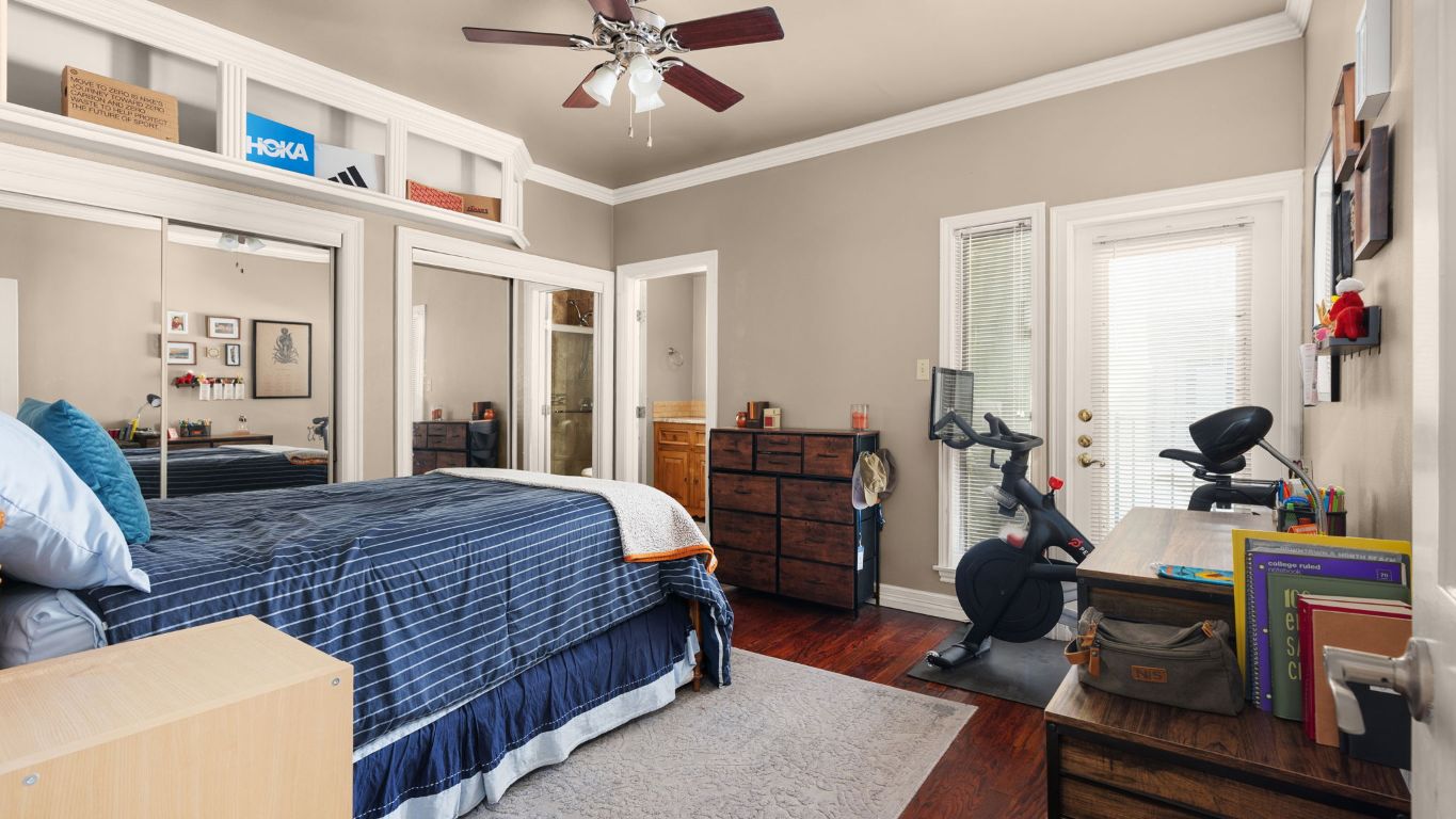 807 West 25th Street, Unit 207 Austin, TX 78705 - Photo 12 of 25 a bedroom with a bed gym equipment and large windows