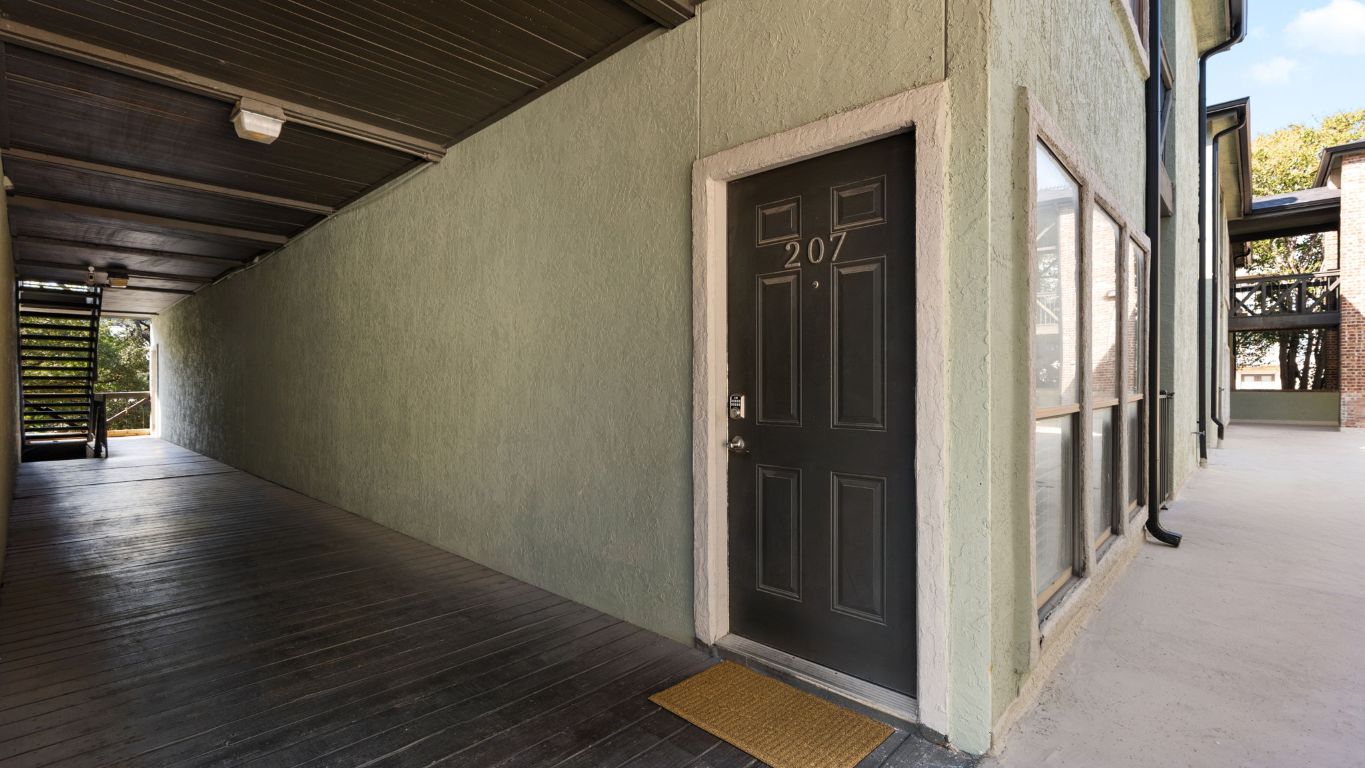807 West 25th Street, Unit 207 Austin, TX 78705 - Photo 20 of 25 a view of a hallway with wooden floor