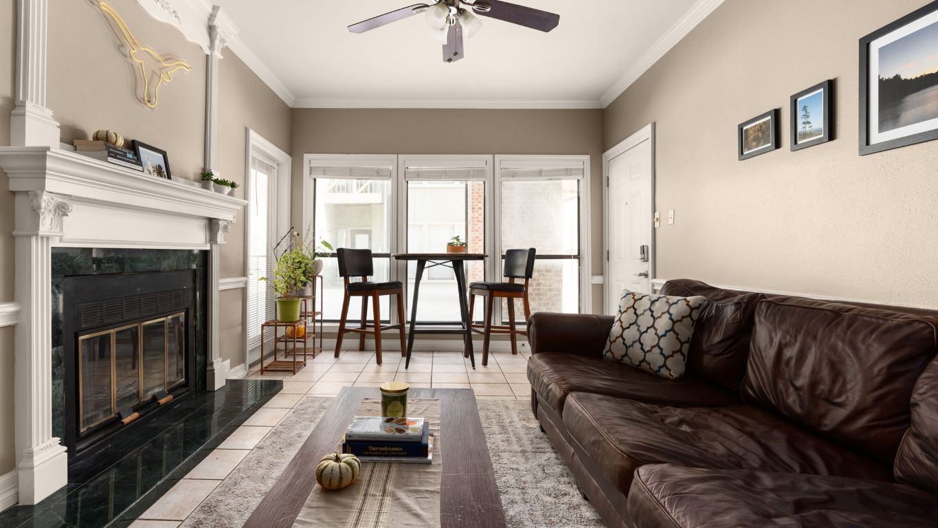 807 West 25th Street, Unit 207 Austin, TX 78705 - Photo 3 of 25 a living room with furniture and a fireplace