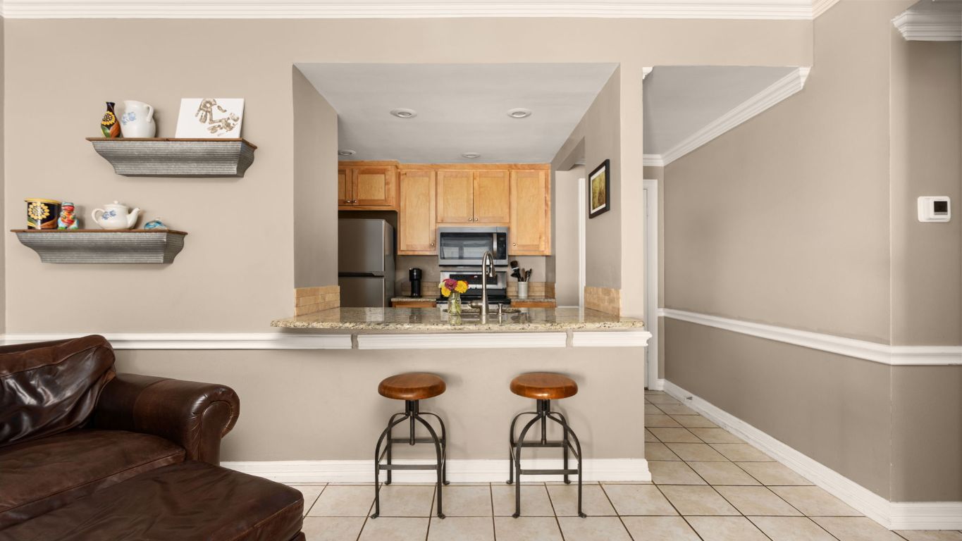 807 West 25th Street, Unit 207 Austin, TX 78705 - Photo 5 of 25 a living room with furniture and a window