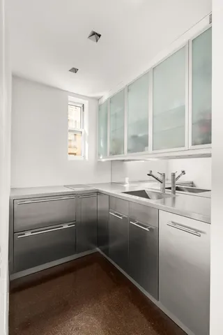 a kitchen with sink cabinets and window