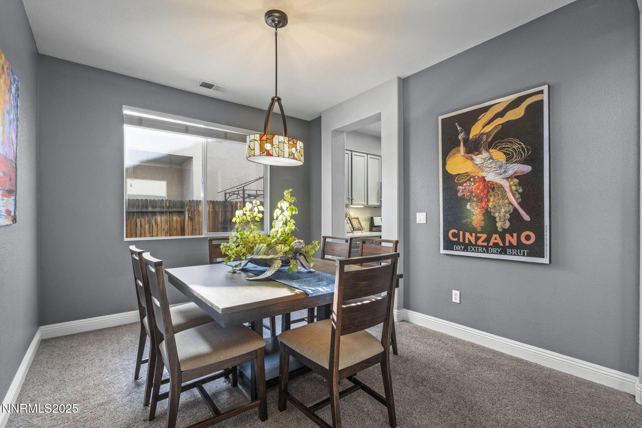 10431 Silver Rush Court Reno, NV 89521 - Photo 9 of 26 a dining room with furniture a painting and a chandelier