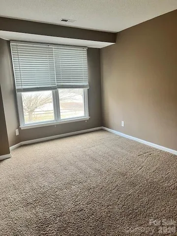 an empty room with a empty space and windows