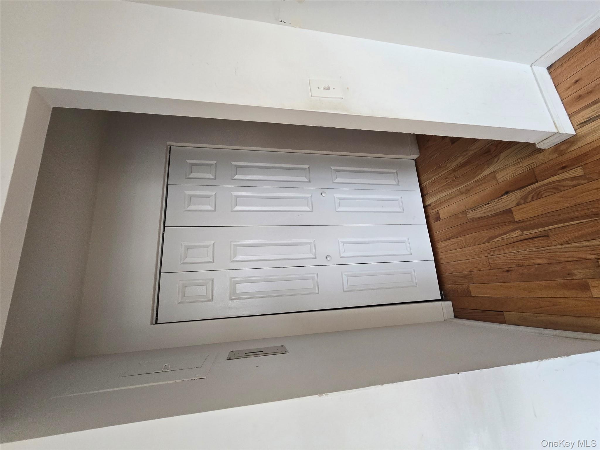 34-12 113th Street, Unit 9B Queens, NY 11368 - Photo 5 of 7 an empty room with wooden floor