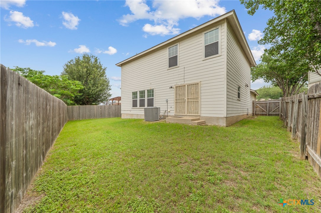 109 Comal Cove Elgin, TX 78621 - Photo 32 of 34 a view of a backyard with a garden