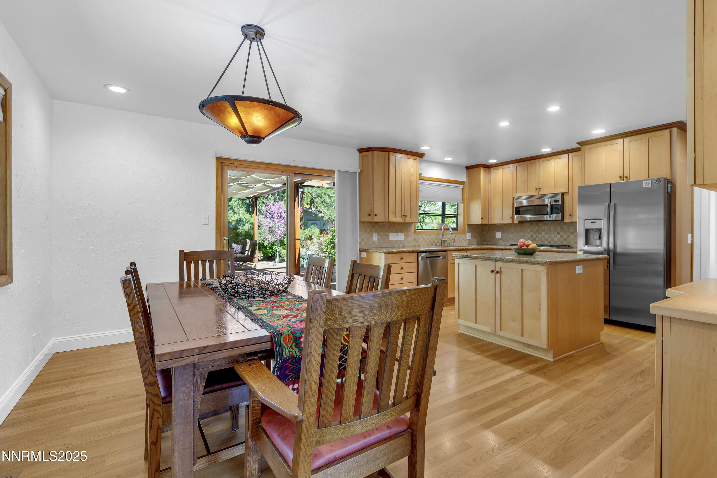1145 Alpine Circle Reno, NV 89509 - Photo 12 of 36 a view of a dining room with furniture wooden floor and chandelier