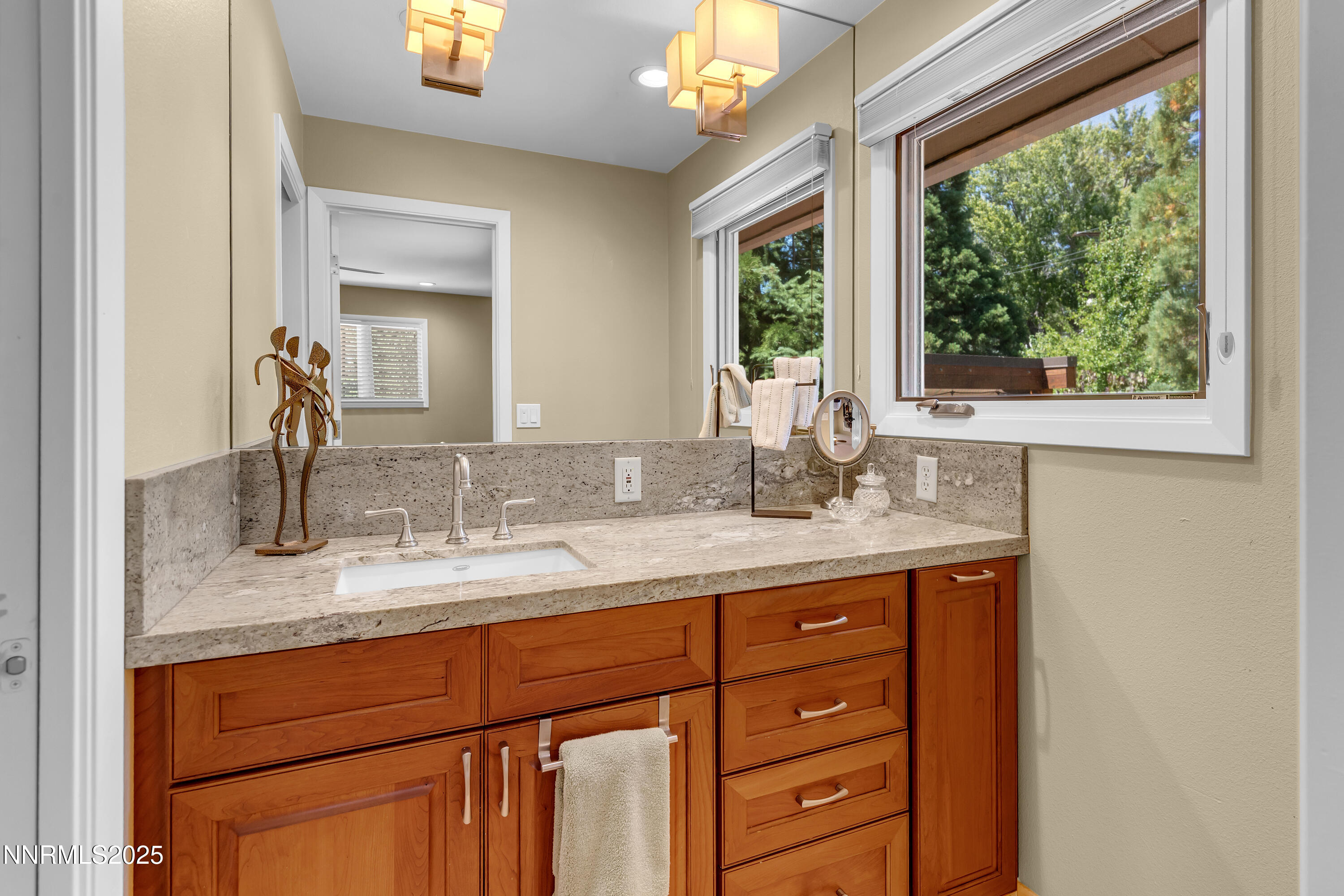 1145 Alpine Circle Reno, NV 89509 - Photo 23 of 36 a bathroom with a granite countertop sink mirror and window