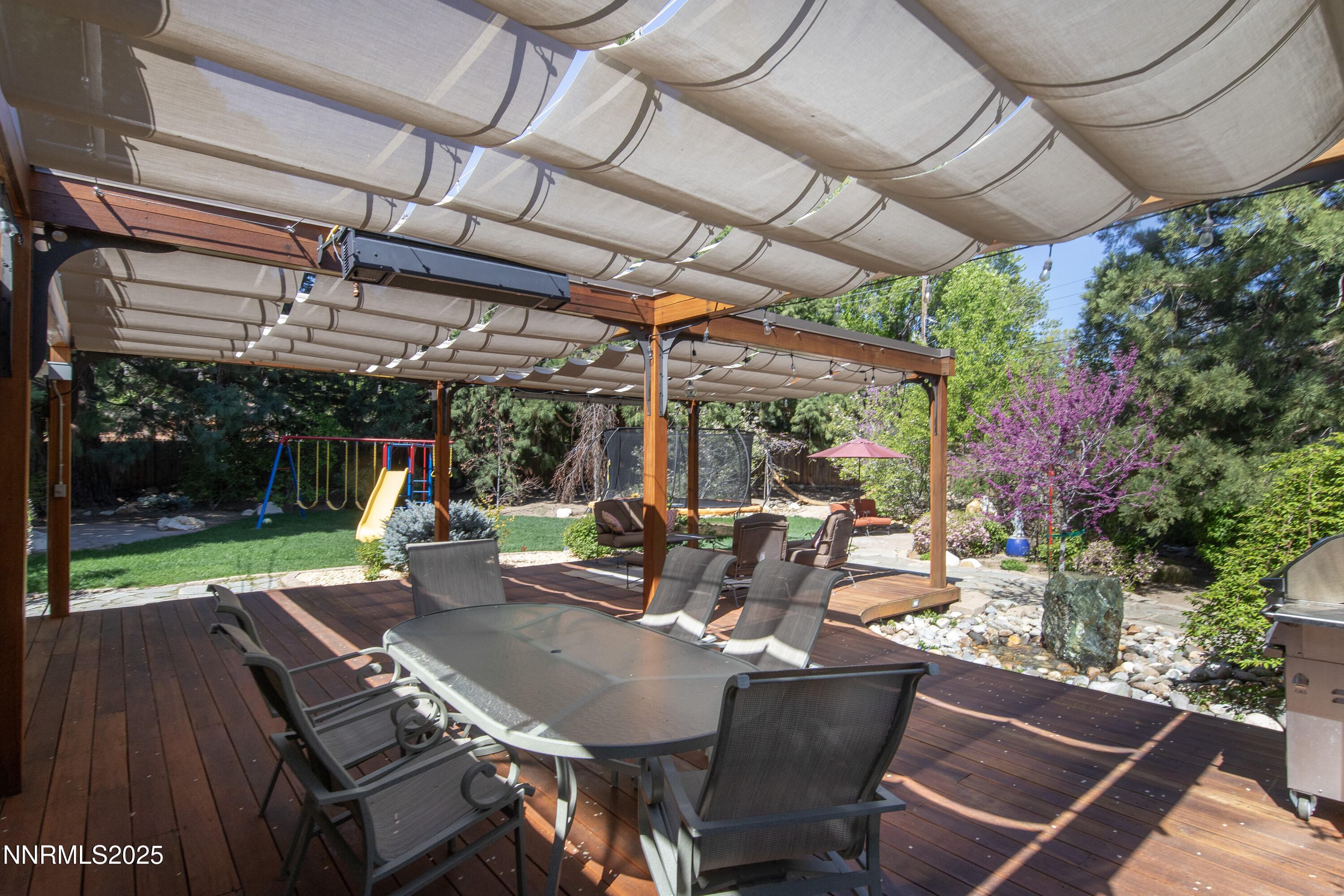 1145 Alpine Circle Reno, NV 89509 - Photo 27 of 36 a view of a patio with a table chairs and a backyard