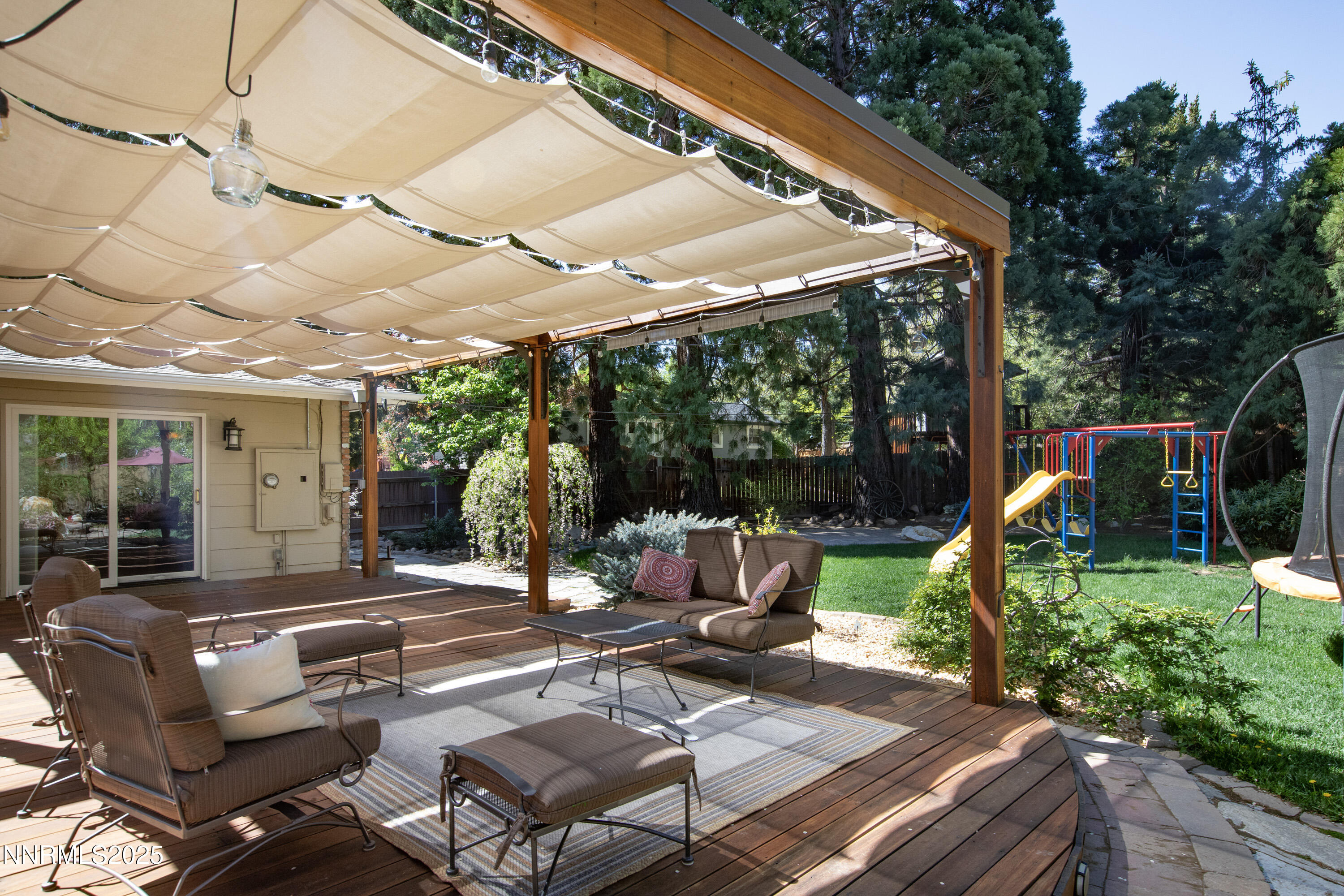 1145 Alpine Circle Reno, NV 89509 - Photo 3 of 36 a view of a patio with table and chairs potted plants and large tree