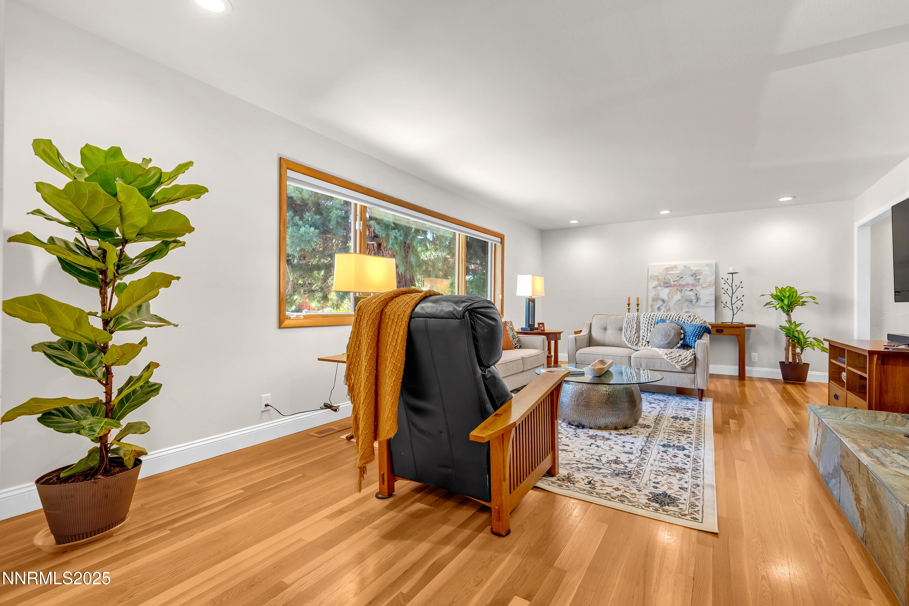 1145 Alpine Circle Reno, NV 89509 - Photo 7 of 36 a living room with furniture hard wood floor and a potted plant