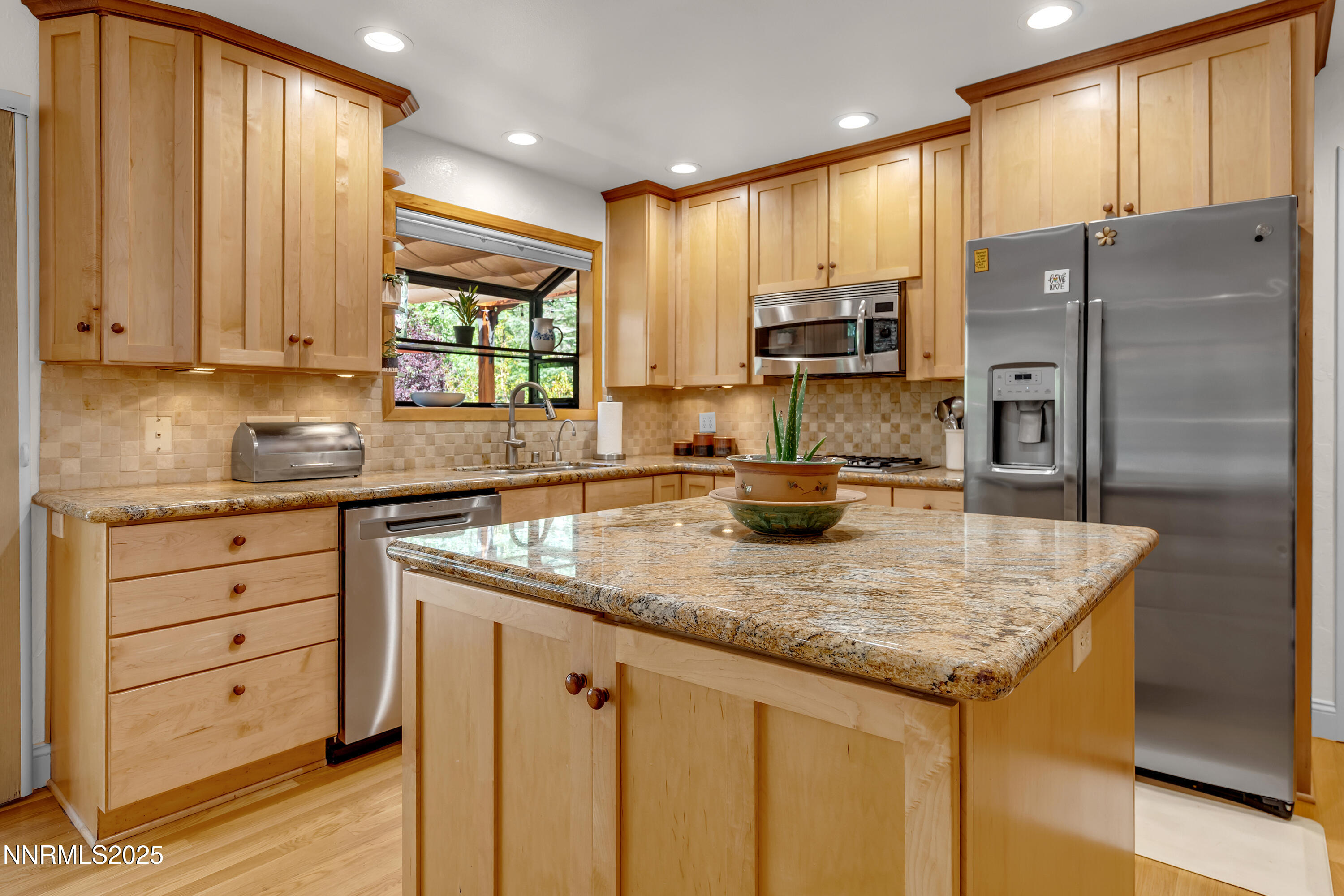 1145 Alpine Circle Reno, NV 89509 - Photo 9 of 36 a kitchen with stainless steel appliances granite countertop a sink refrigerator and cabinets