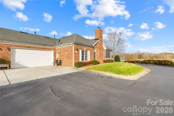 a view of a house with a yard and garage