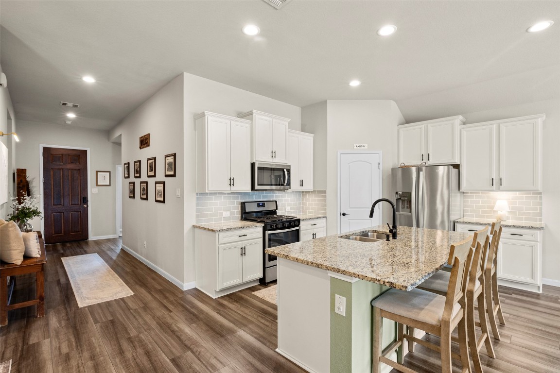 14239 Volcano Perch Drive Conroe, TX 77384 - Photo 12 of 39 a kitchen with stainless steel appliances granite countertop a refrigerator and a stove top oven