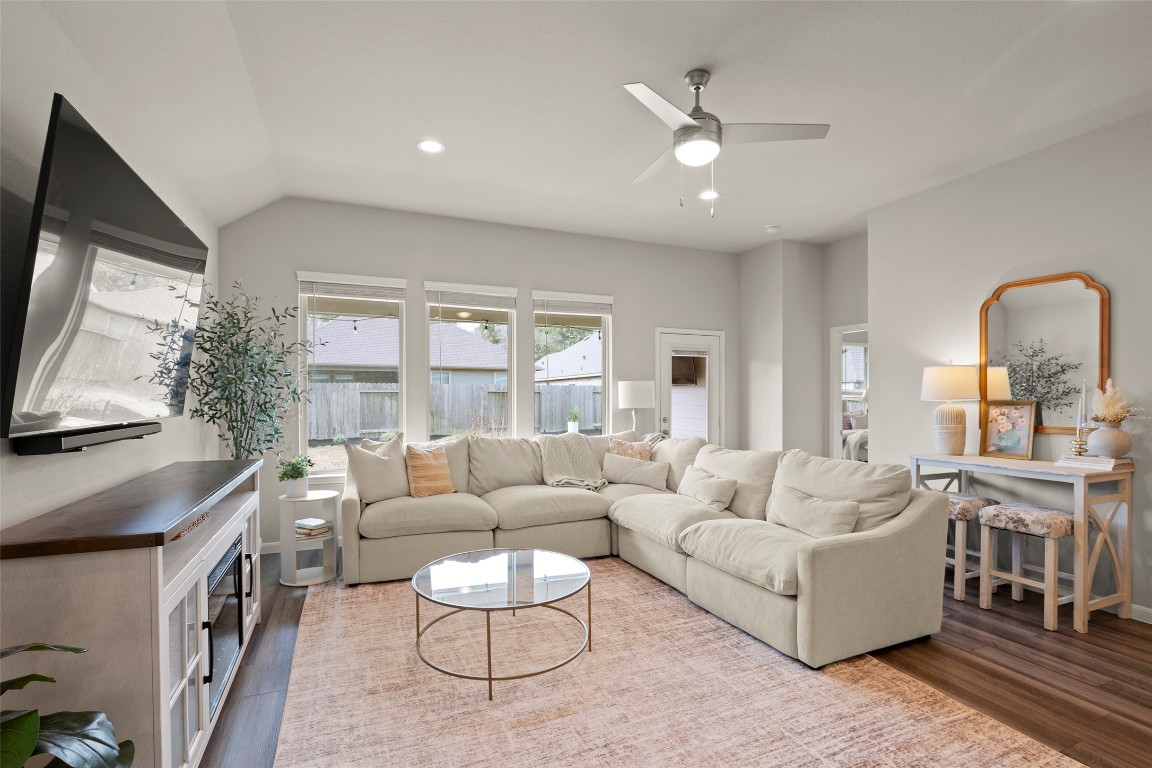 14239 Volcano Perch Drive Conroe, TX 77384 - Photo 16 of 39 a living room with furniture a flat screen tv and a large window