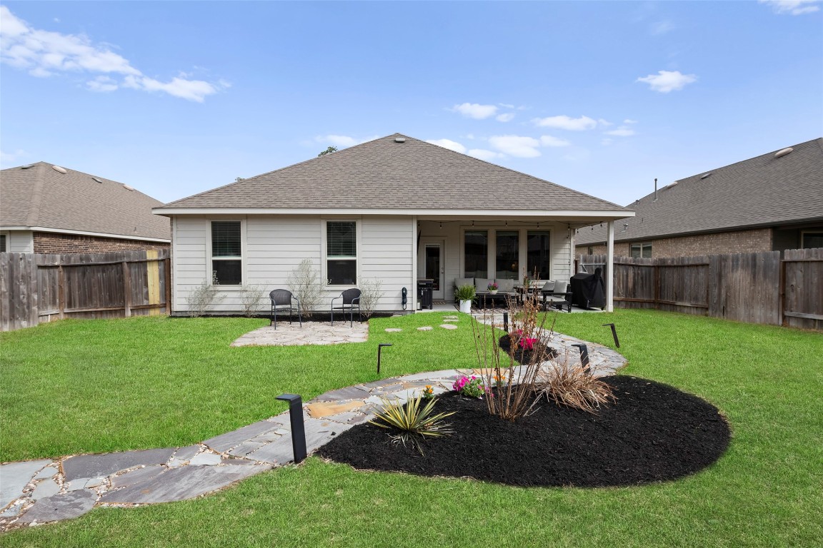 14239 Volcano Perch Drive Conroe, TX 77384 - Photo 32 of 39 a view of a house with backyard sitting area and garden